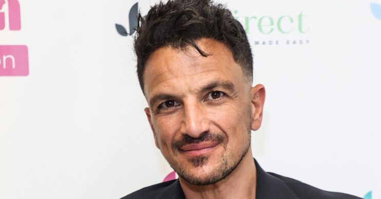 Peter Andre smiles as he poses for the camera