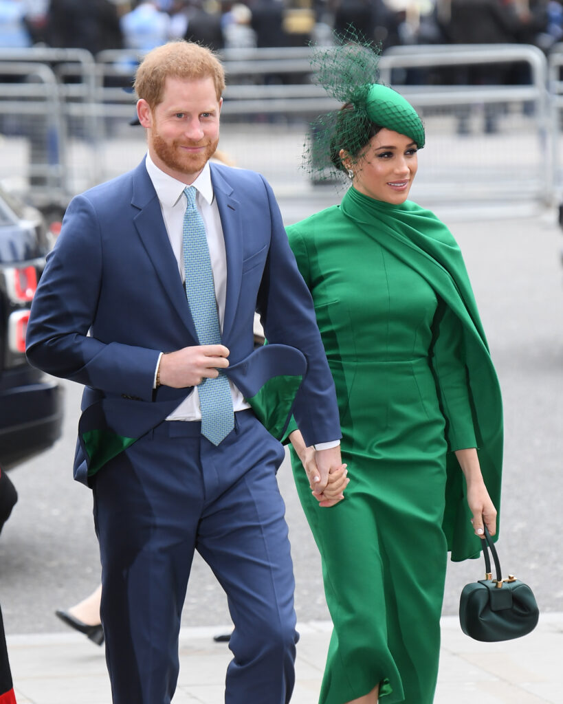 Prince Harry and Meghan Markle holding hands at royal service in 2020