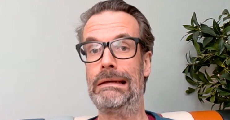 Marcus Brigstocke miming the fate of his character on Death In Paradise