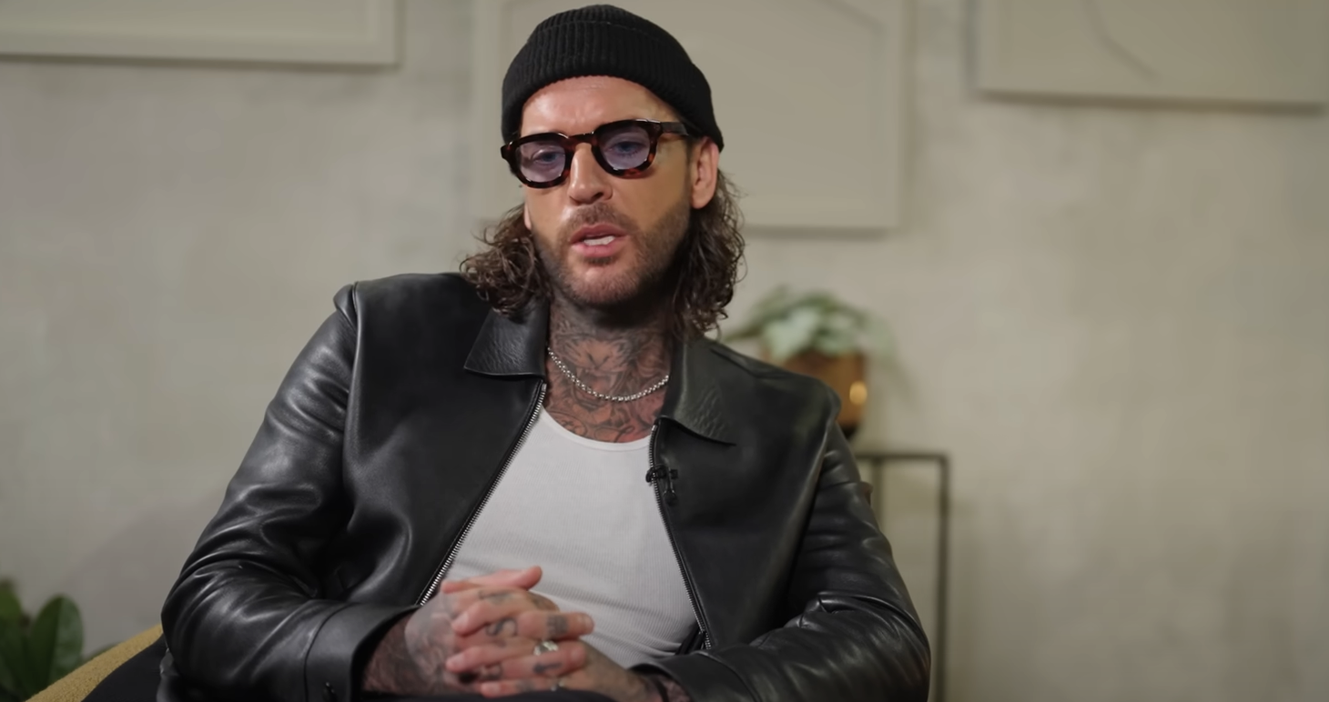 Pete Wicks wearing a hat speaking on a podcast