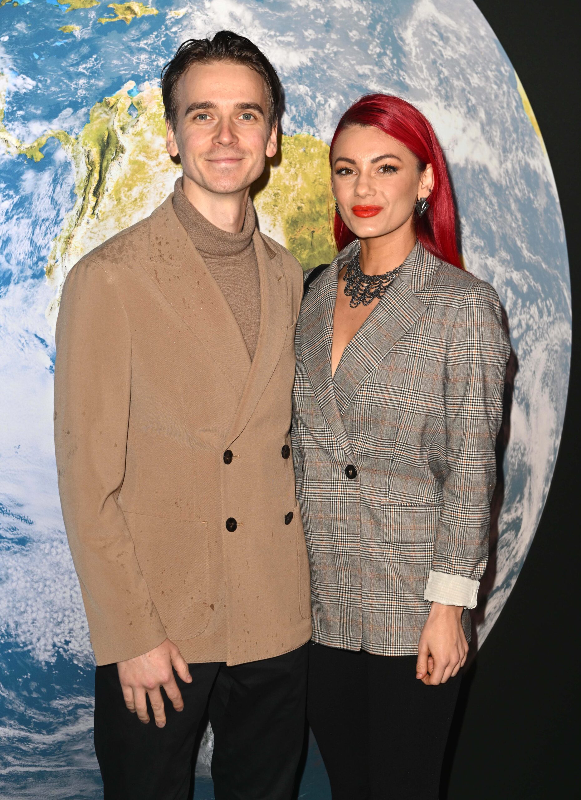 Dianne Buswell and Joe Snugg stand next to each other as they pose for cameras