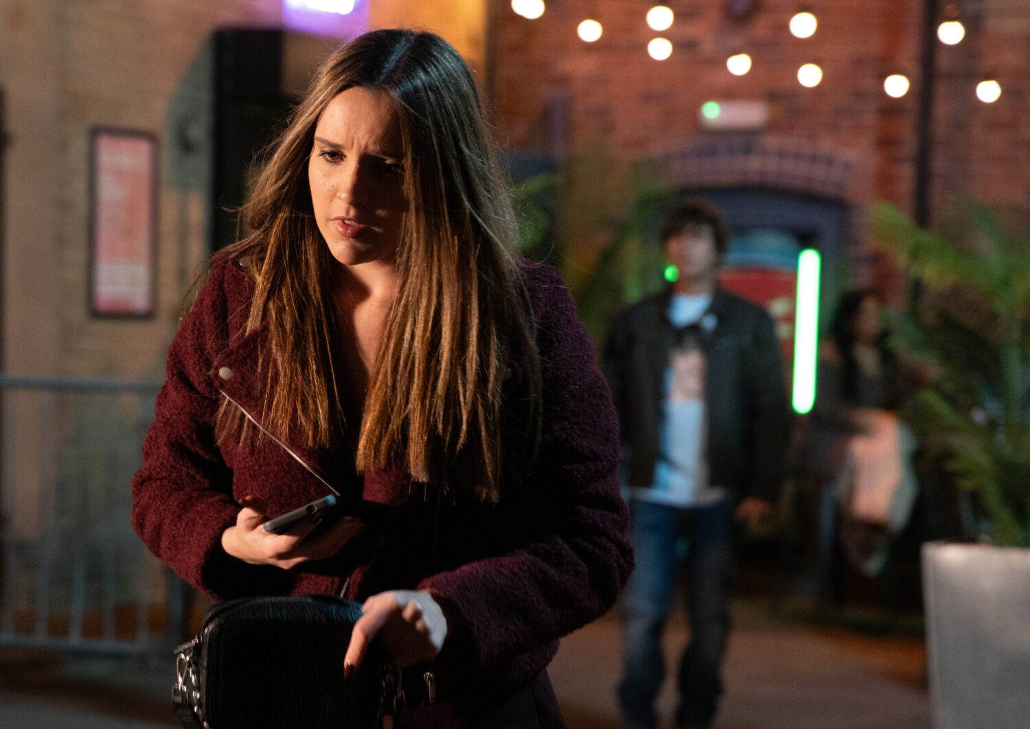 Amy walking away from Eric on a night out