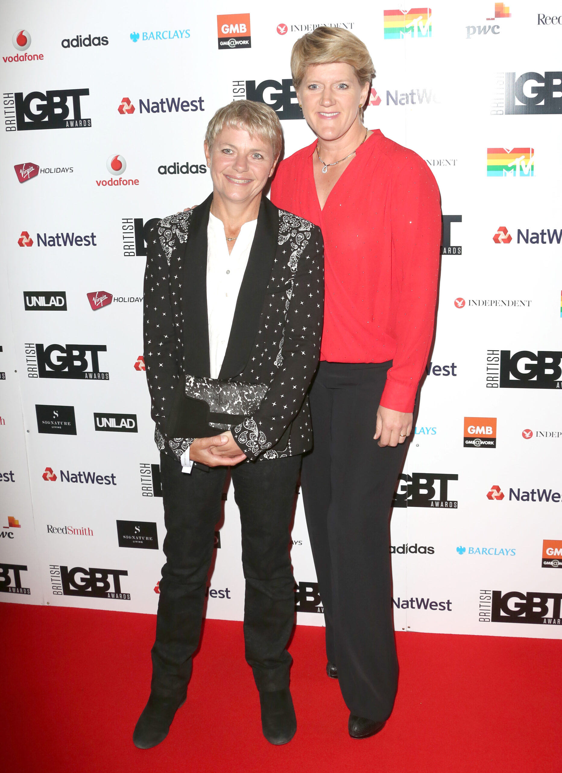 Clare Balding smiles as she stands next to wife Alice Arnold