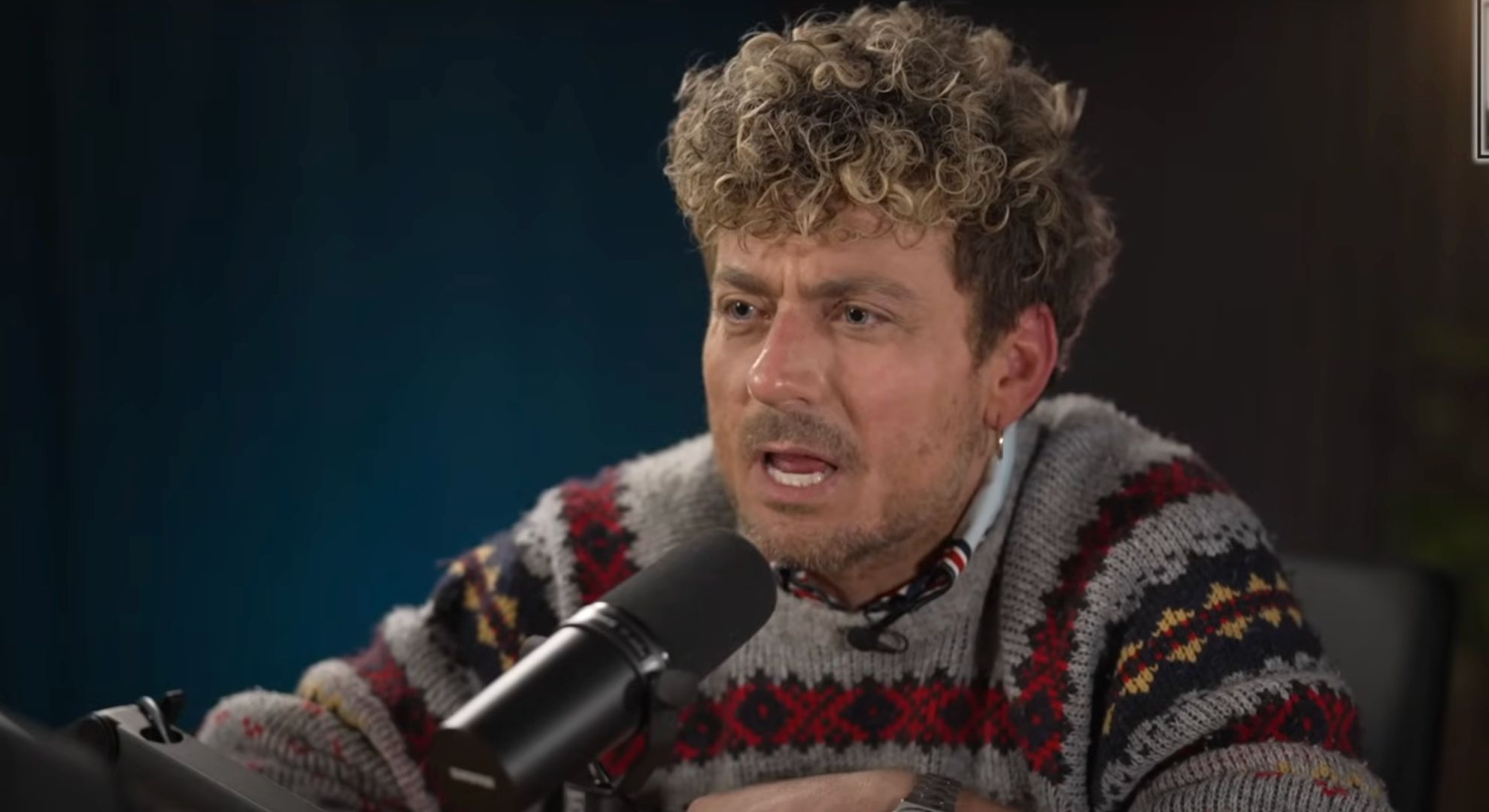 Paul Danan speaking on a podcast