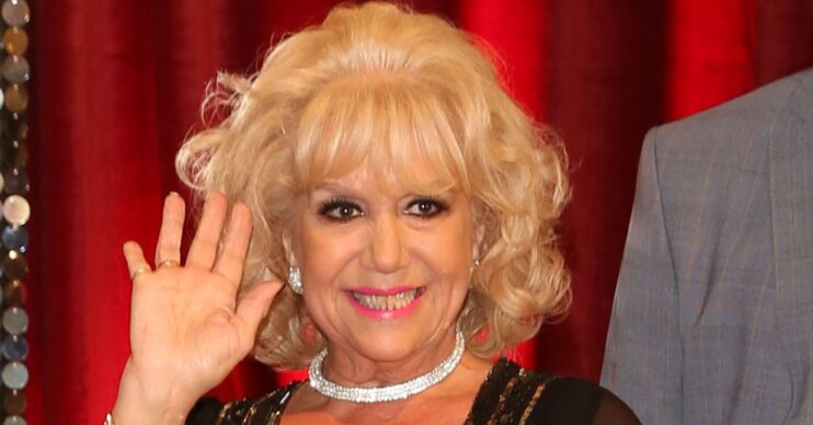 Diane Langton smiling and waving
