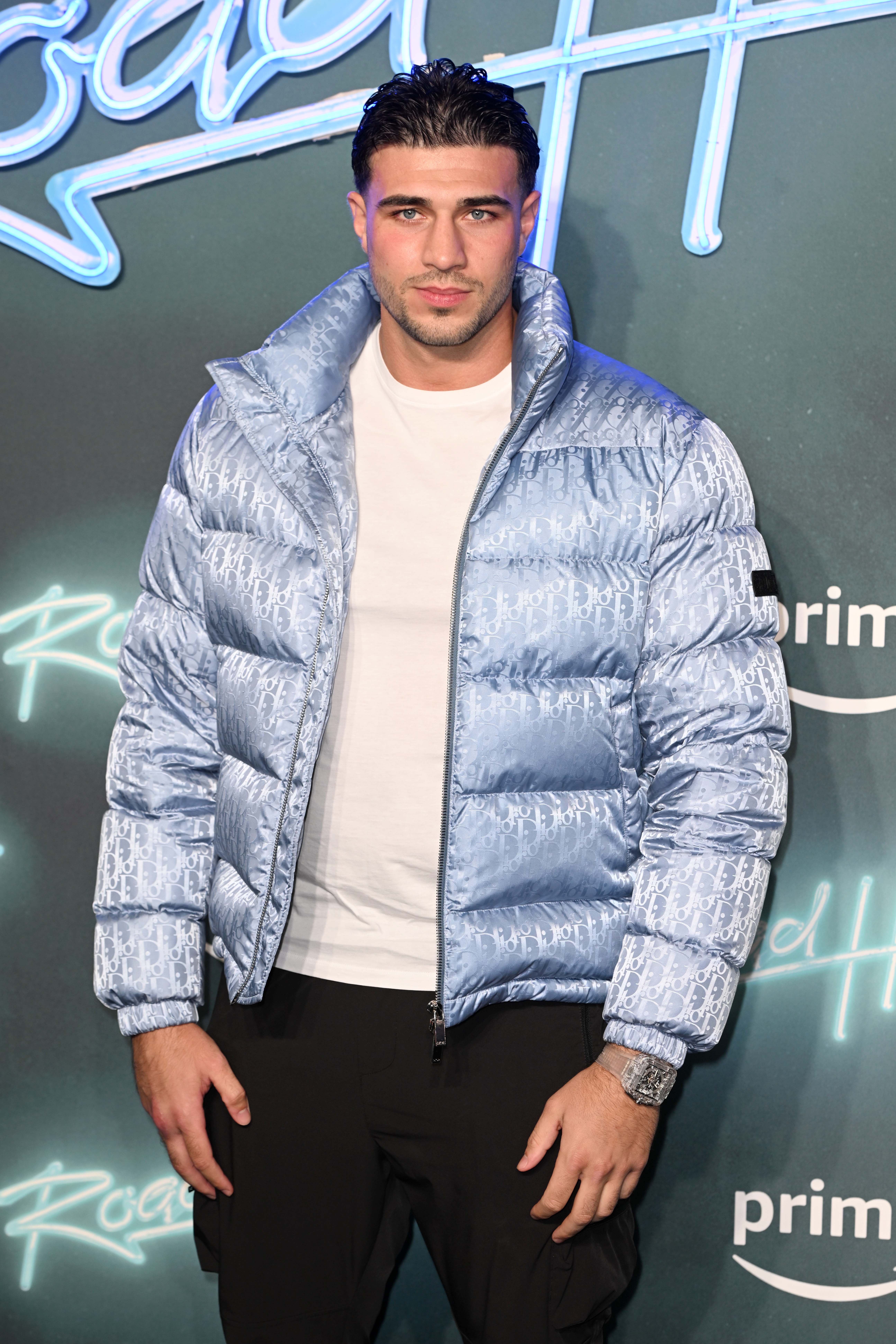 Tommy Fury on the red carpet in a blue jacket