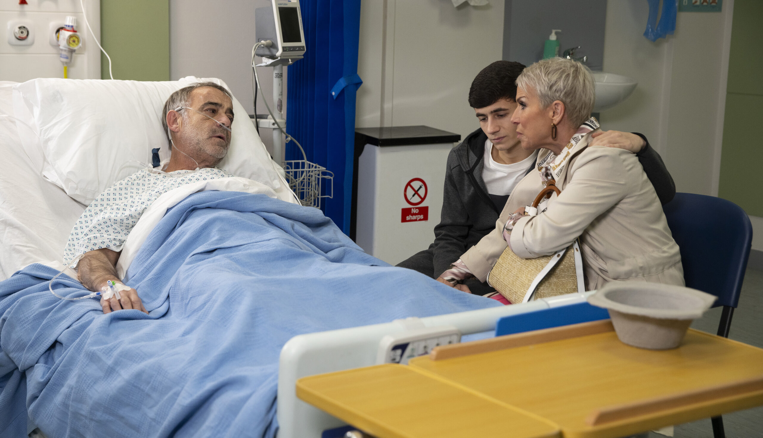 Kevin in the hospital bed with Jack and Debbie by his side