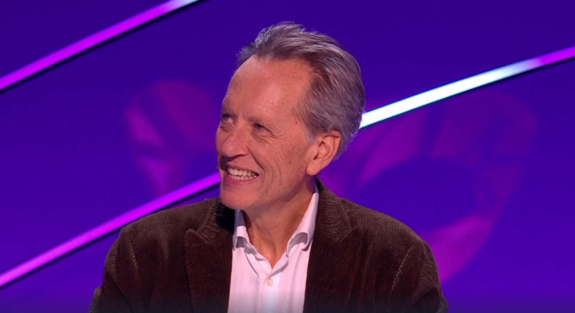 Richard E Grant smiling on The Masked Singer 