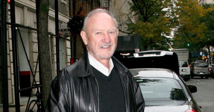 Gene Hackman wears a black leather jacket, sweater and white shirt in New York City