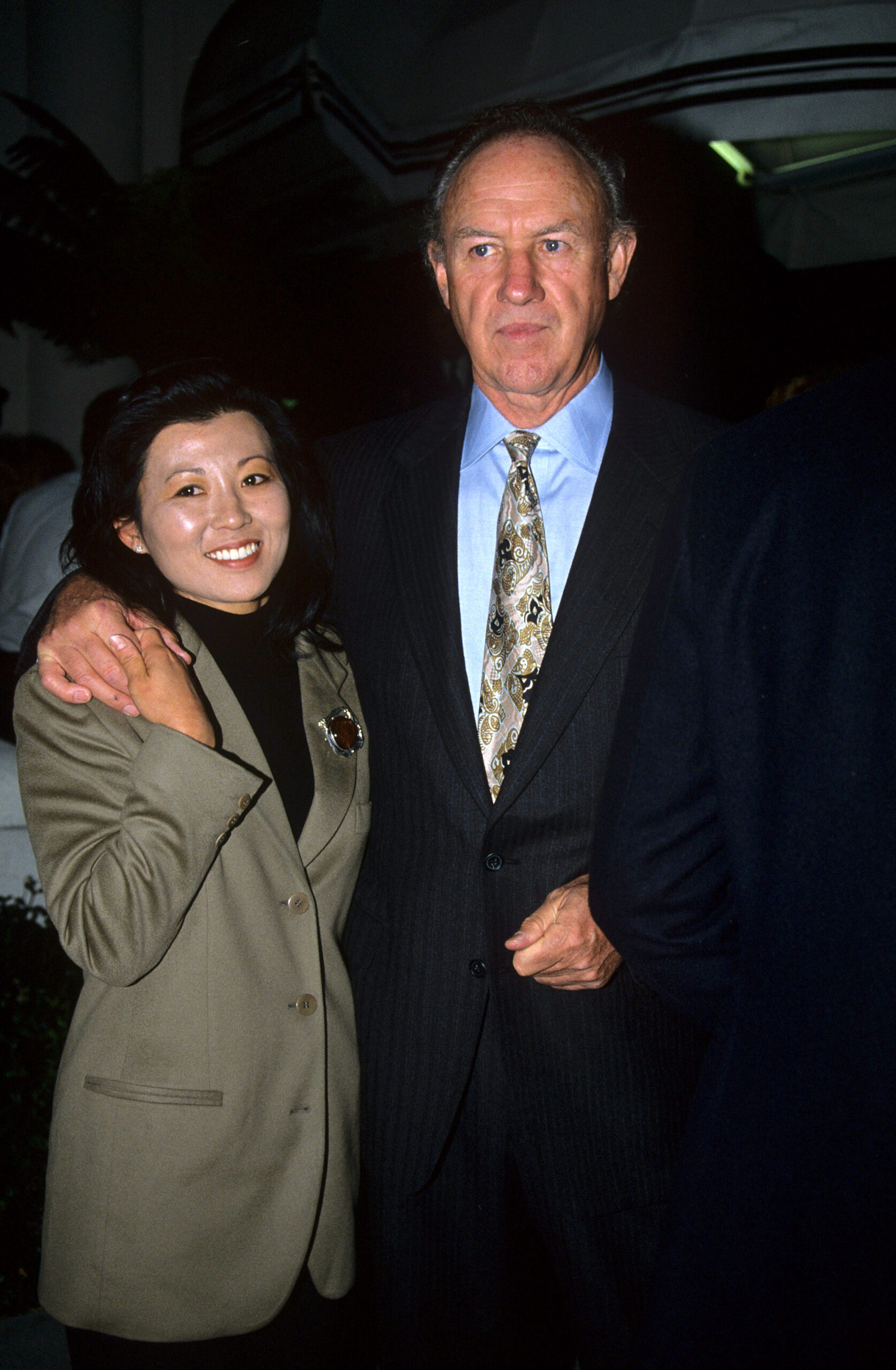 Gene Hackman smiling with his wife