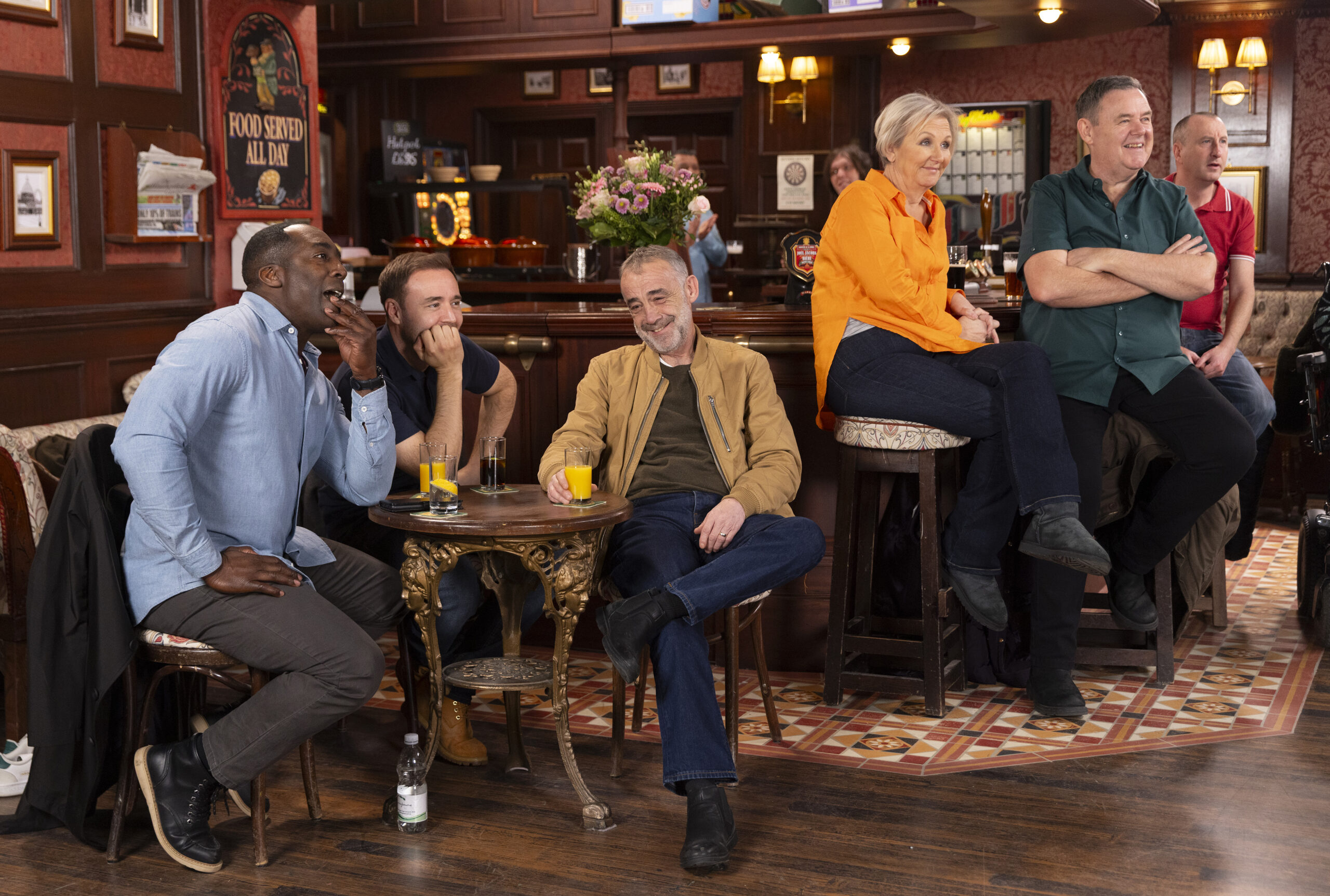 Ronnie, Tyrone and Kevin smiling in the pub