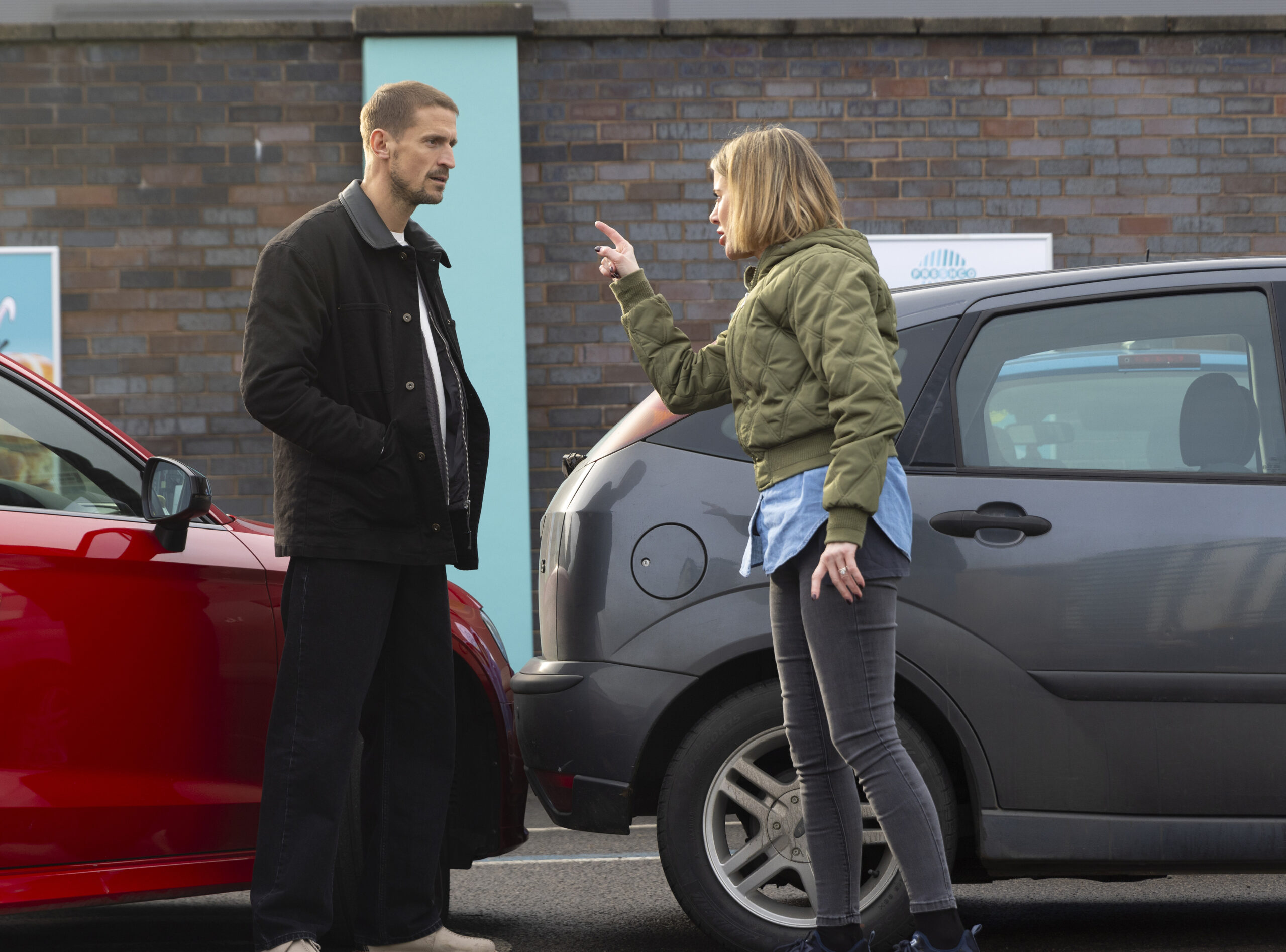 Abi aggressively pointing a finger at Carl Webster