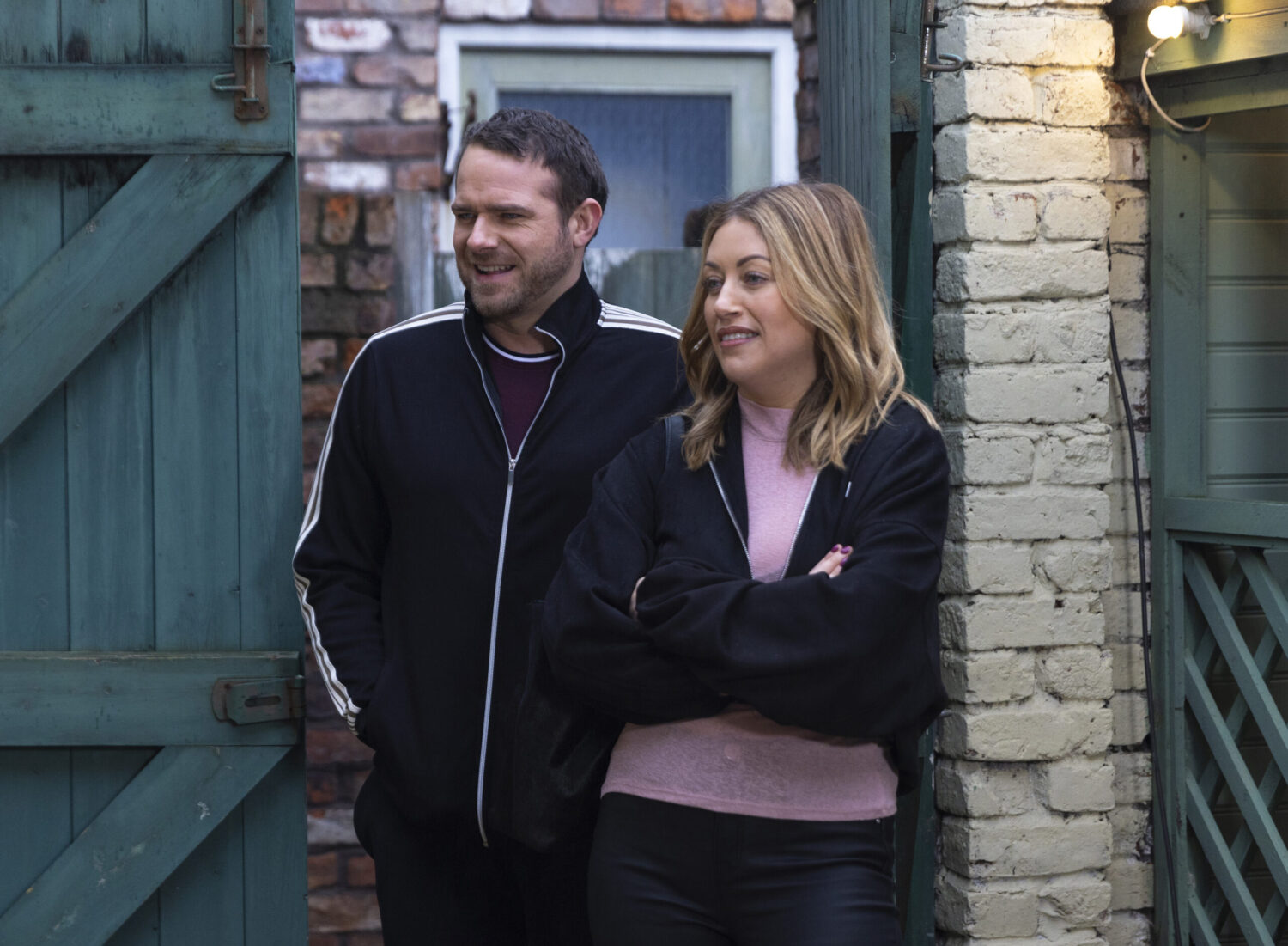 Mick and Lou stand outdoors on Corrie