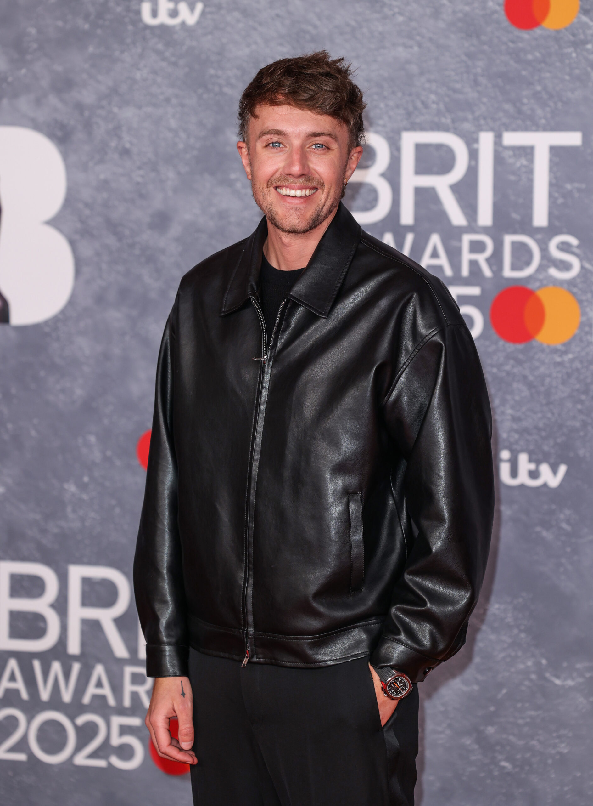 Roman Kemp smiling at Brit awards red carpet 