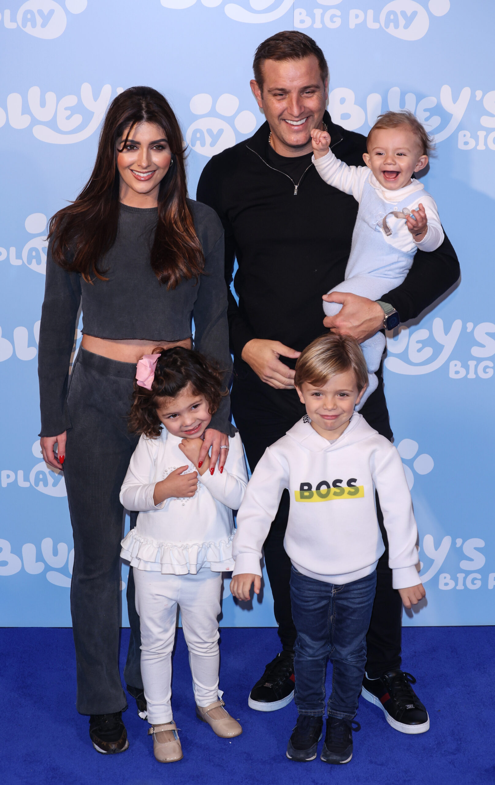 Elliott Wright and Sadie Stuart on the red carpet with children