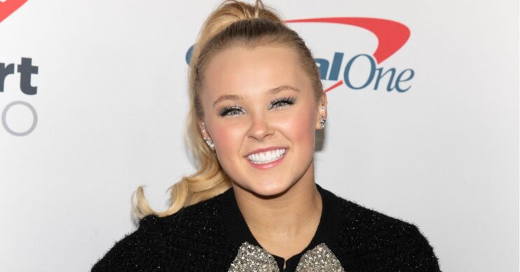 JoJo Siwa smiling on carpet