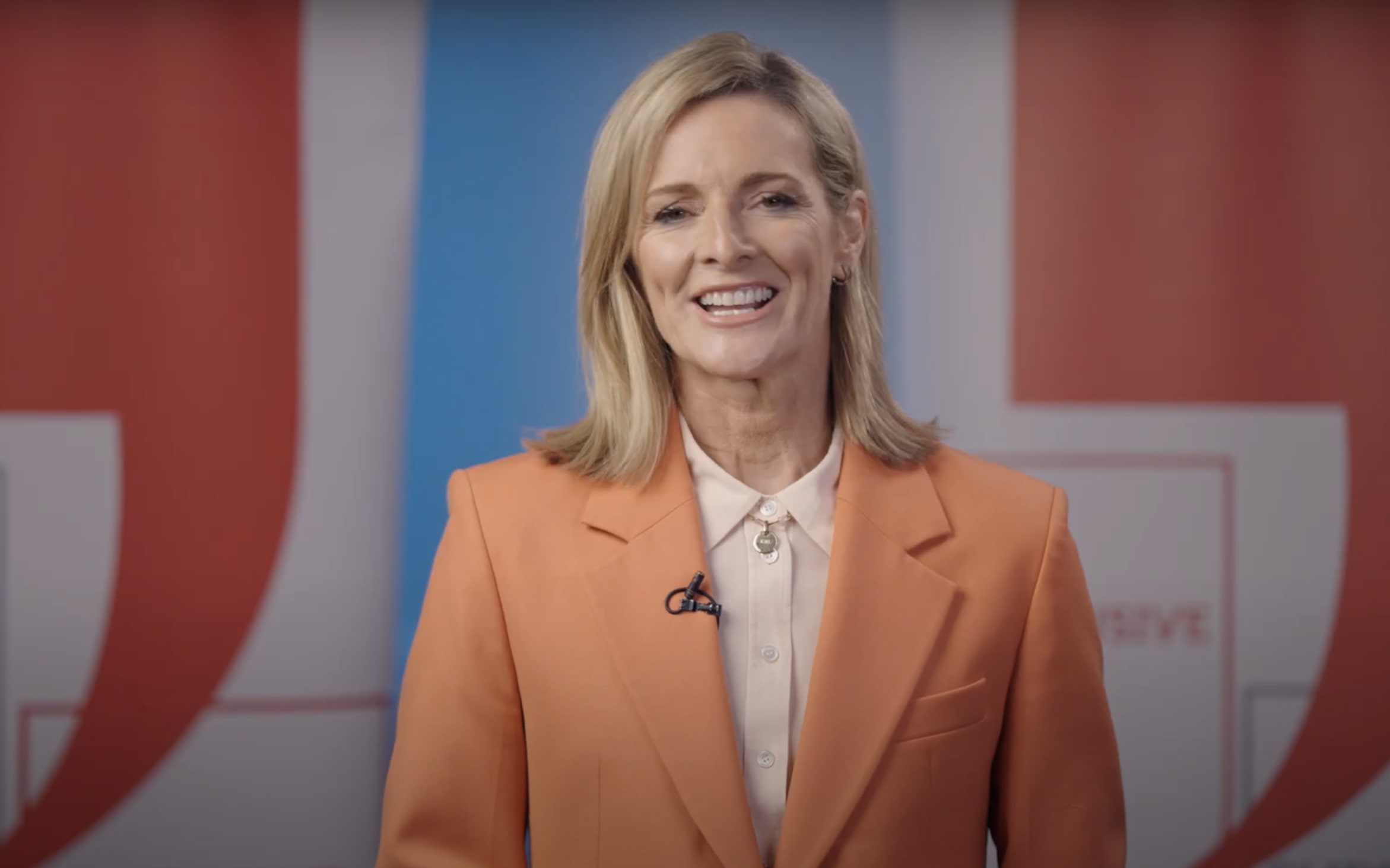 Gabby Logan in an orange suit jacket