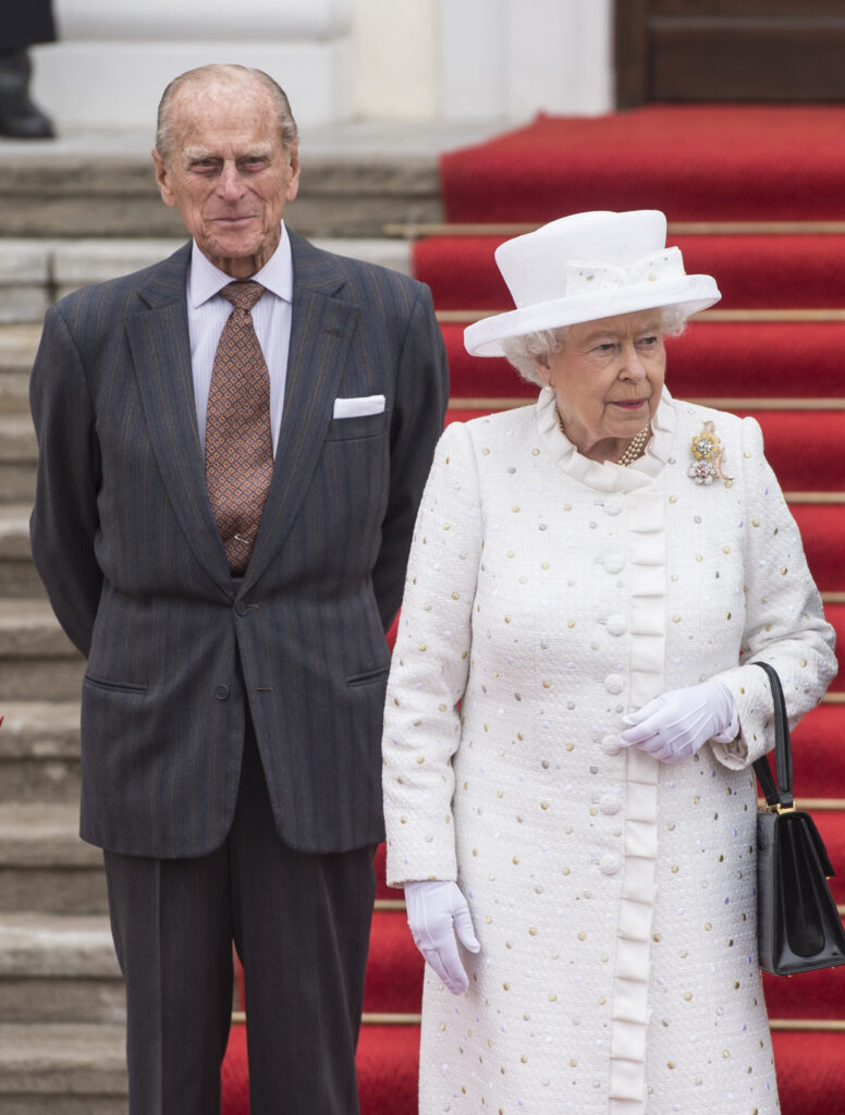 Prince Philip and Queen Elizabeth smile in front of steps