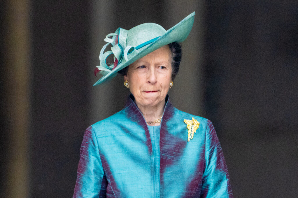 Princess Anne wears a blue dress and teal hat