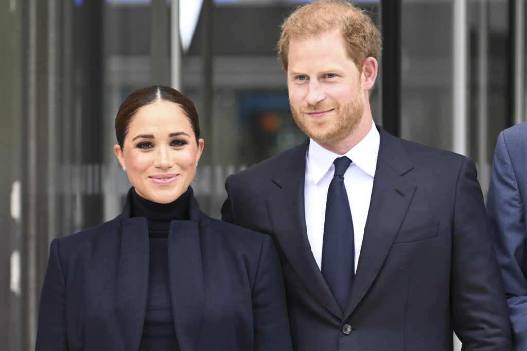 Prince Harry and Meghan Markle wear black outfits and smile