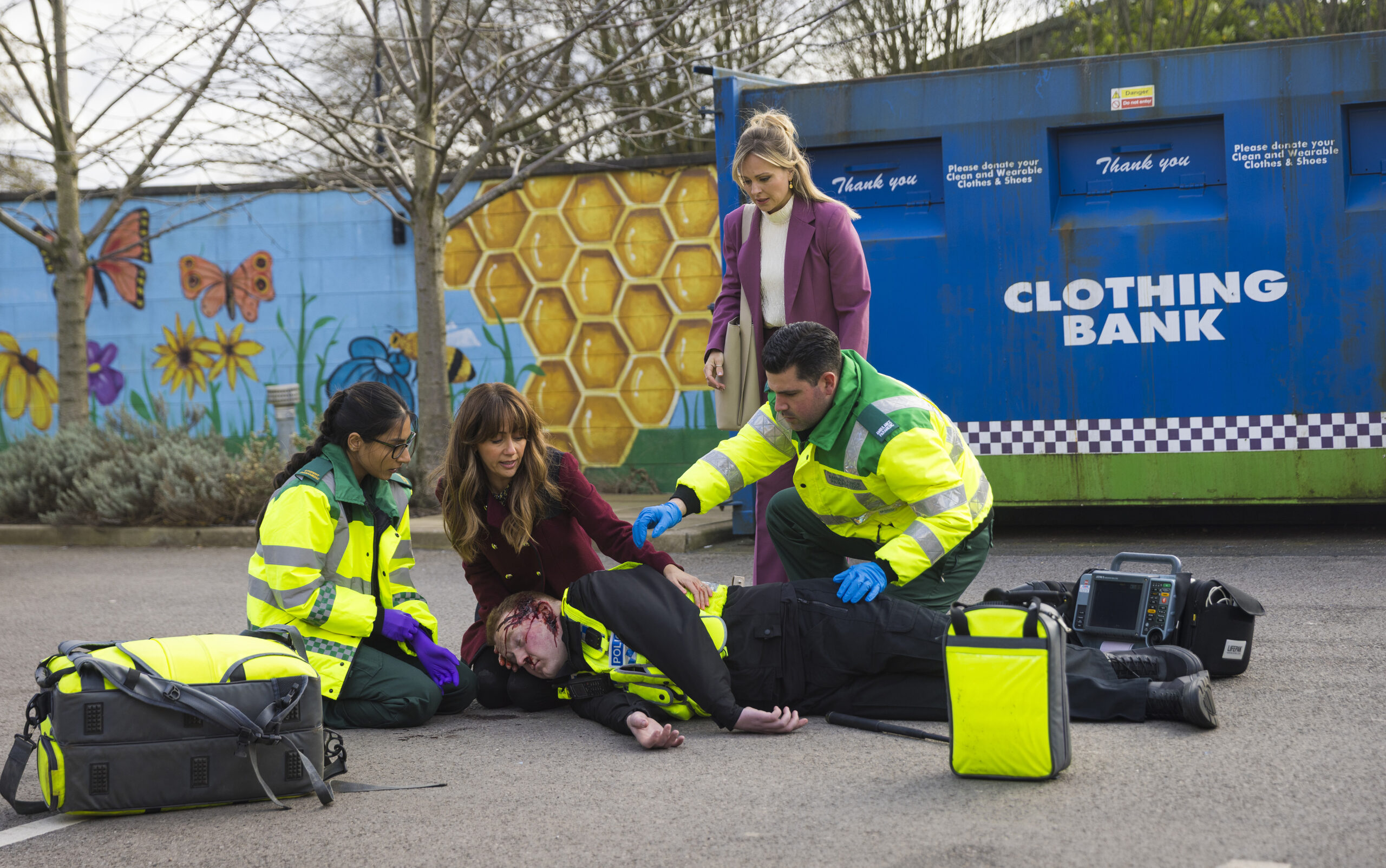 Craig lies beaten up in Coronation Street as Sarah and Maria look over him, while Asha and another paramedic try and save his life