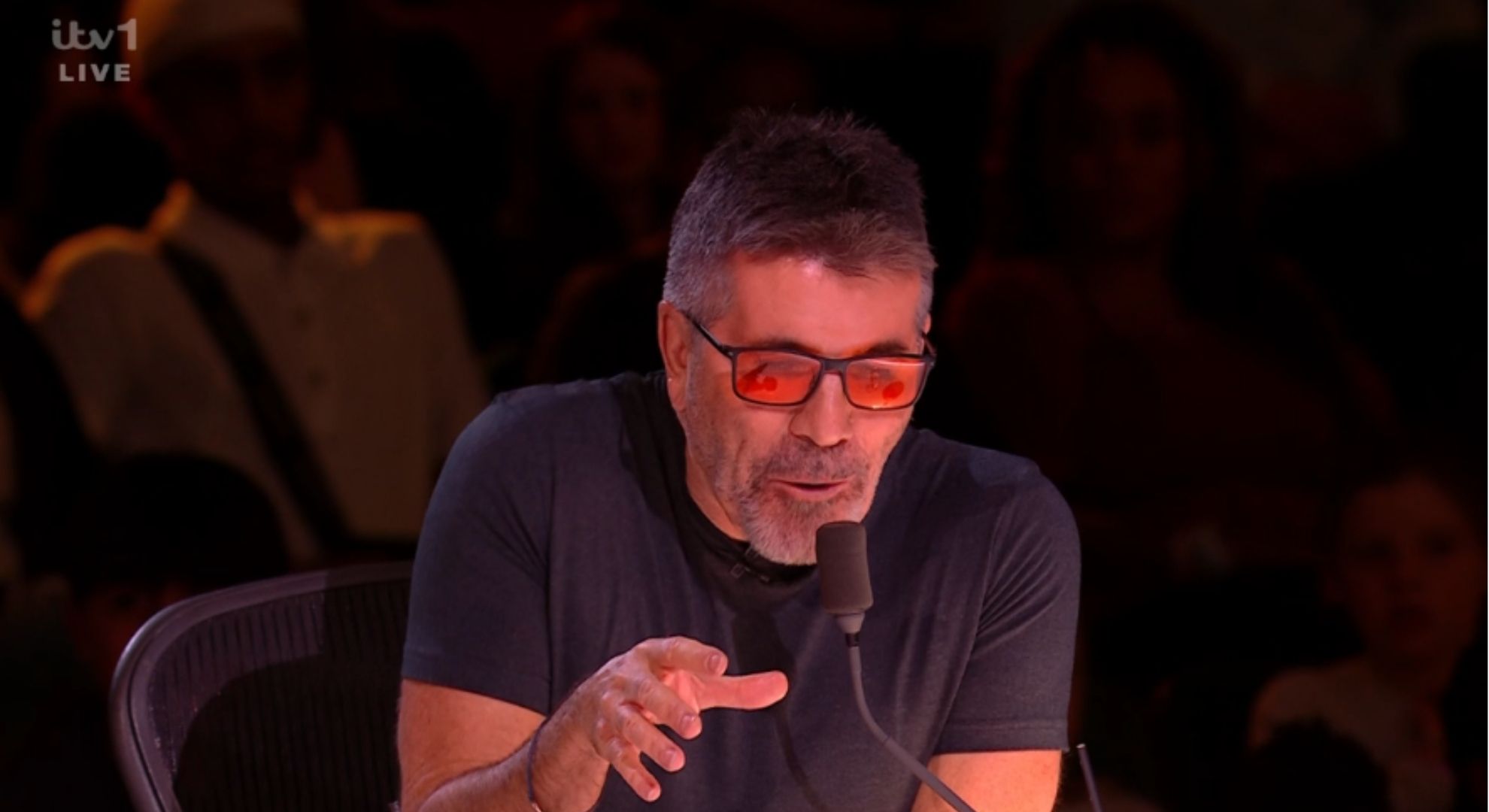 Simon Cowell talking into microphone on BGT