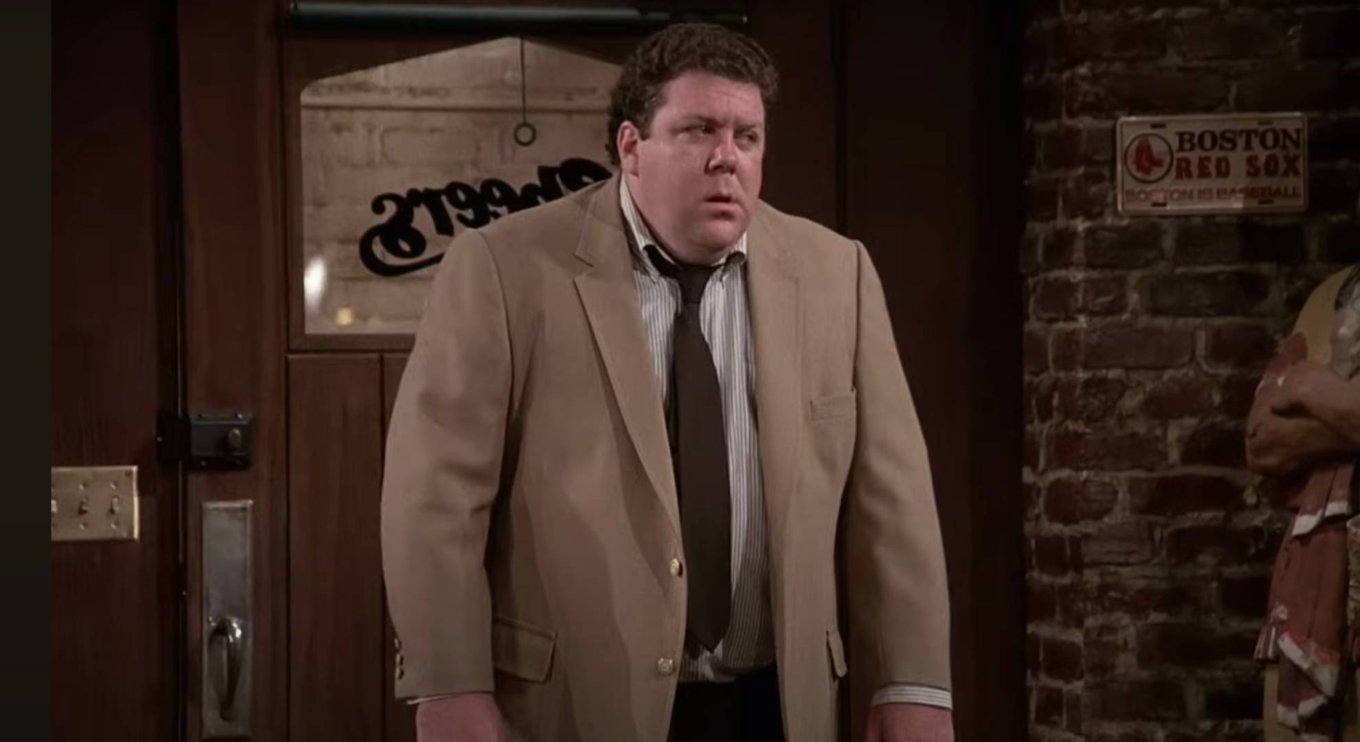 George Wendt looks gruff in character as Norm in Cheers