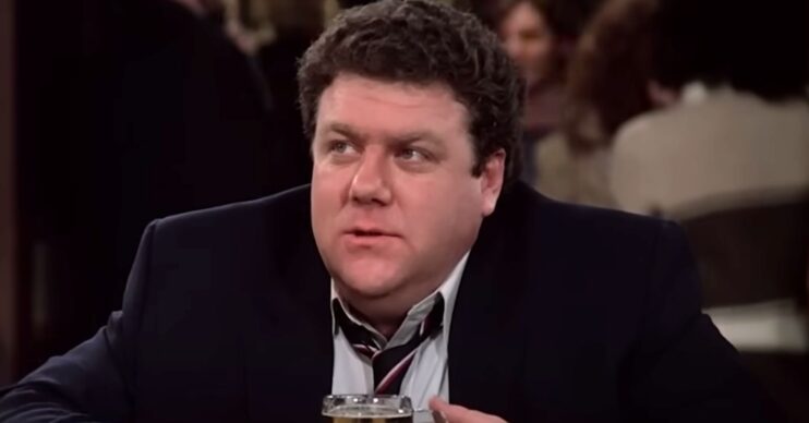 George Wendt in character as Norm looking grumpy on Cheers