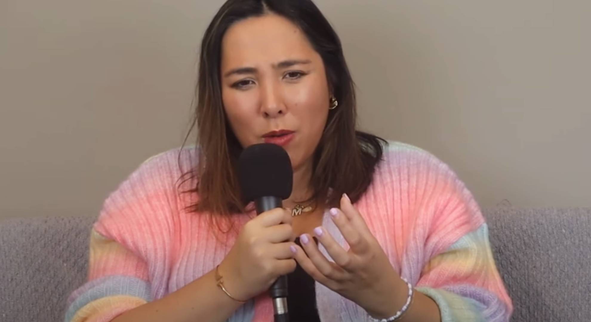 Michelle Elman speaks into a microphone