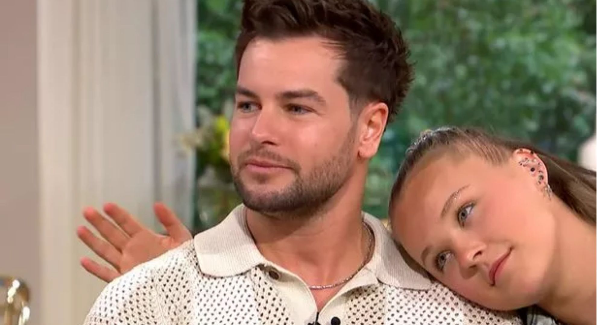 JoJo Siwa resting her head on Chris Hughes shoulder