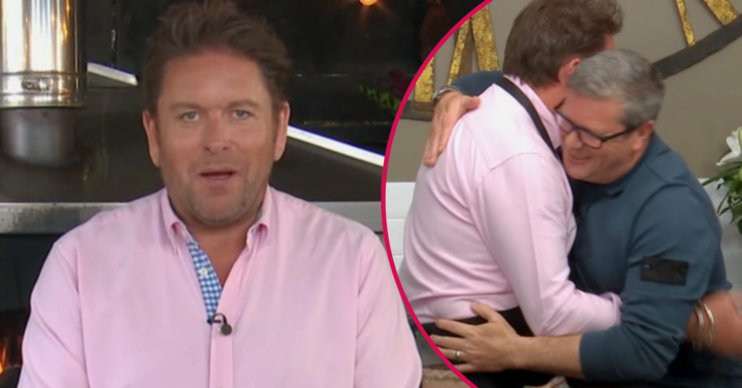 James Martin in a pink shirt and hugging a chef
