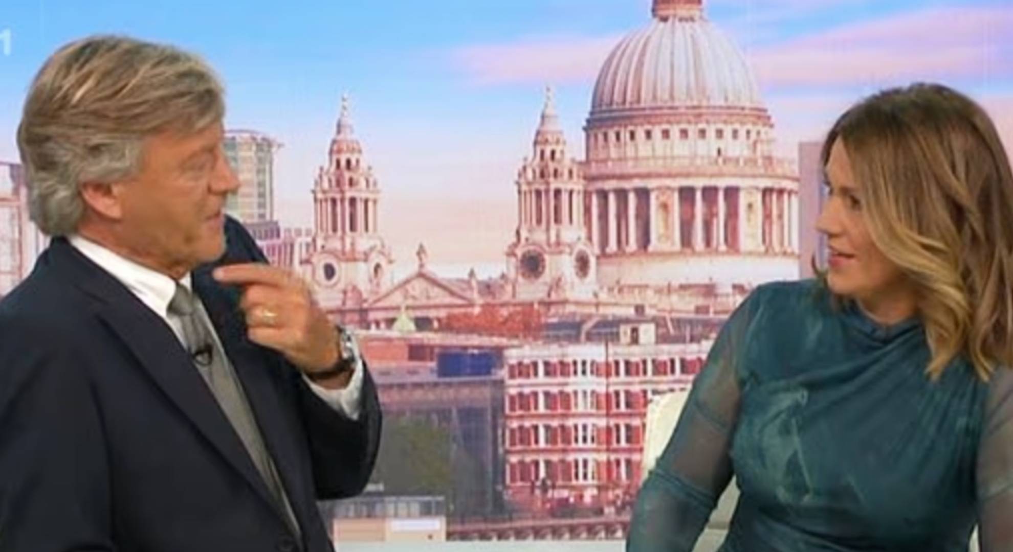 Richard Madeley points at his throat