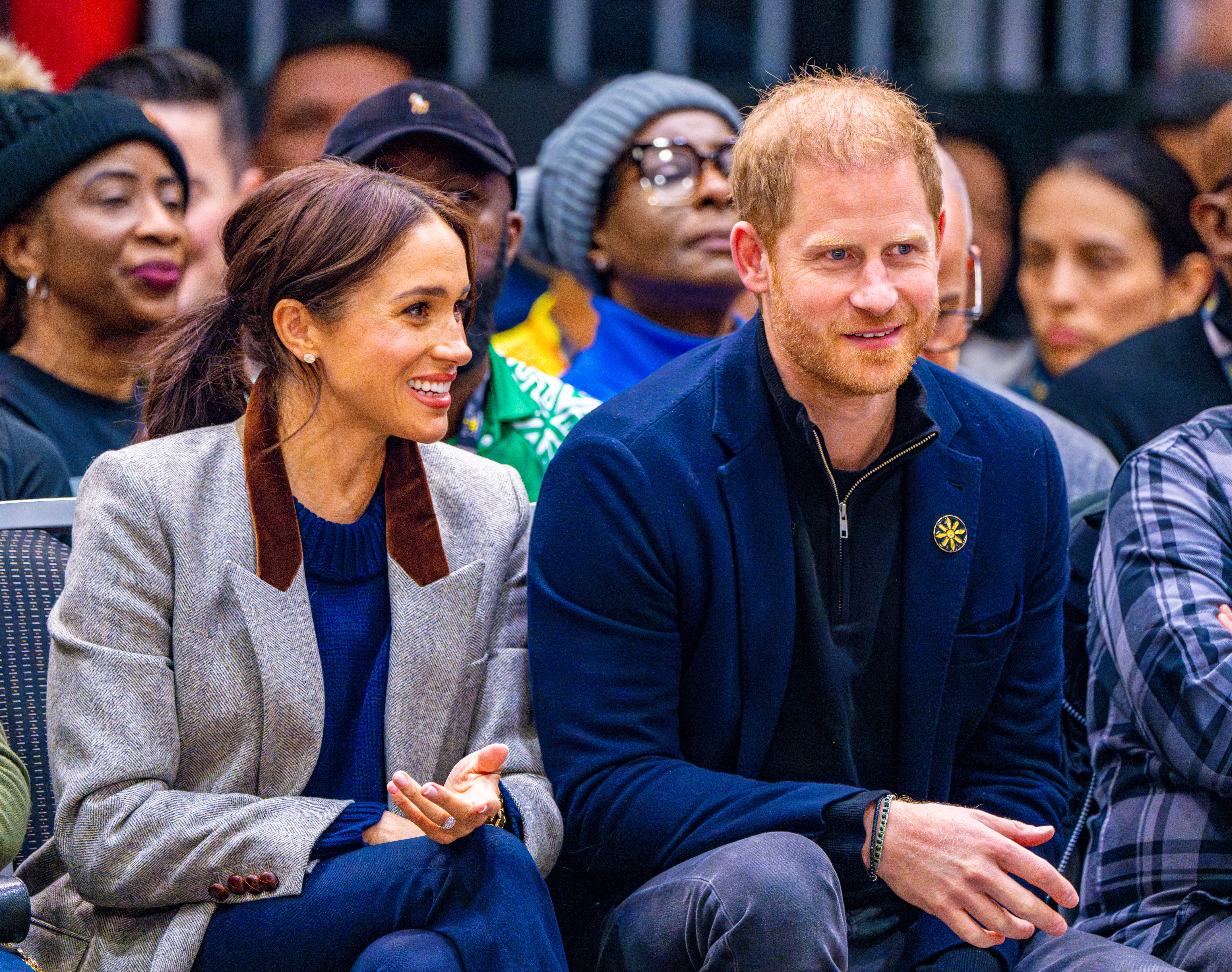 Prince Harry and Meghan Markle smiling and talking at Invictus Games