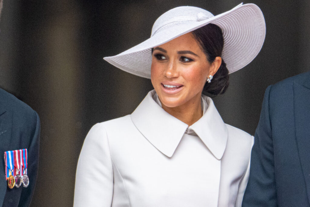 Meghan Markle wears a white hat and dress coat