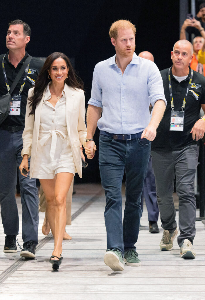 Prince Harry and Meghan Markle hold hands