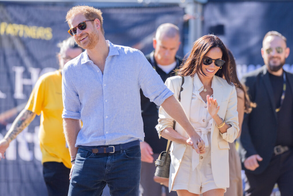 Prince Harry and Meghan Markle hold hands