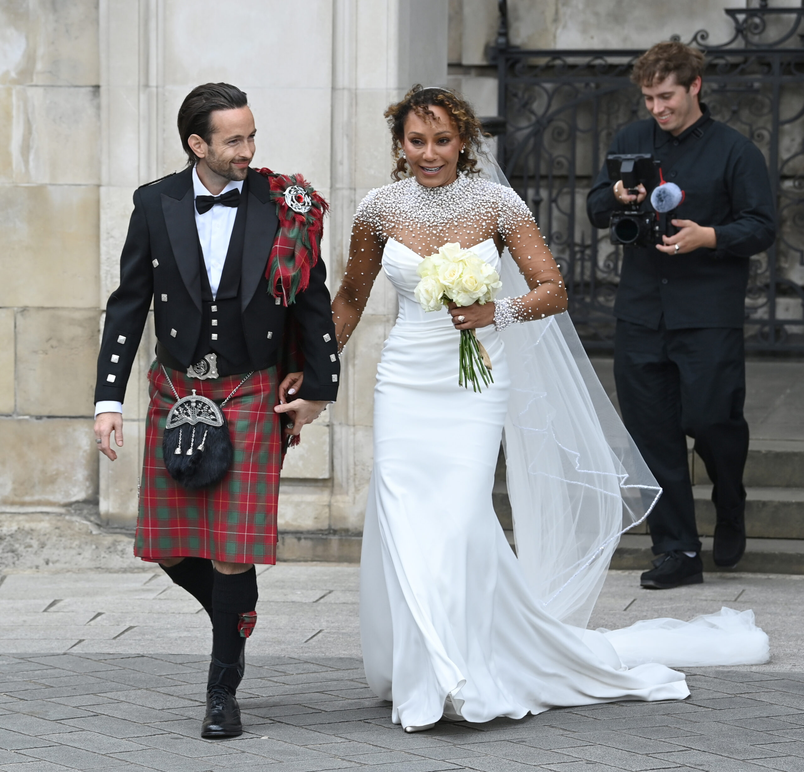 Mel and husband smiling at wedding
