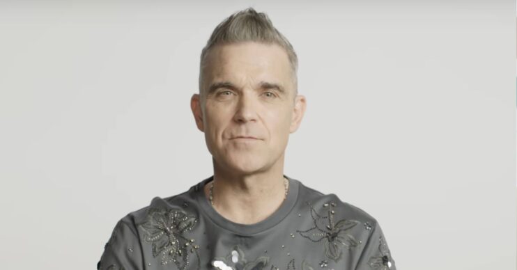 Robbie Williams speaking to camera