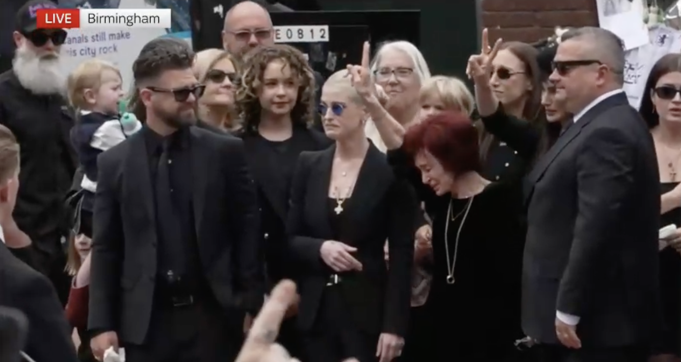 Sharon doing rock symbol at Ozzy's funeral