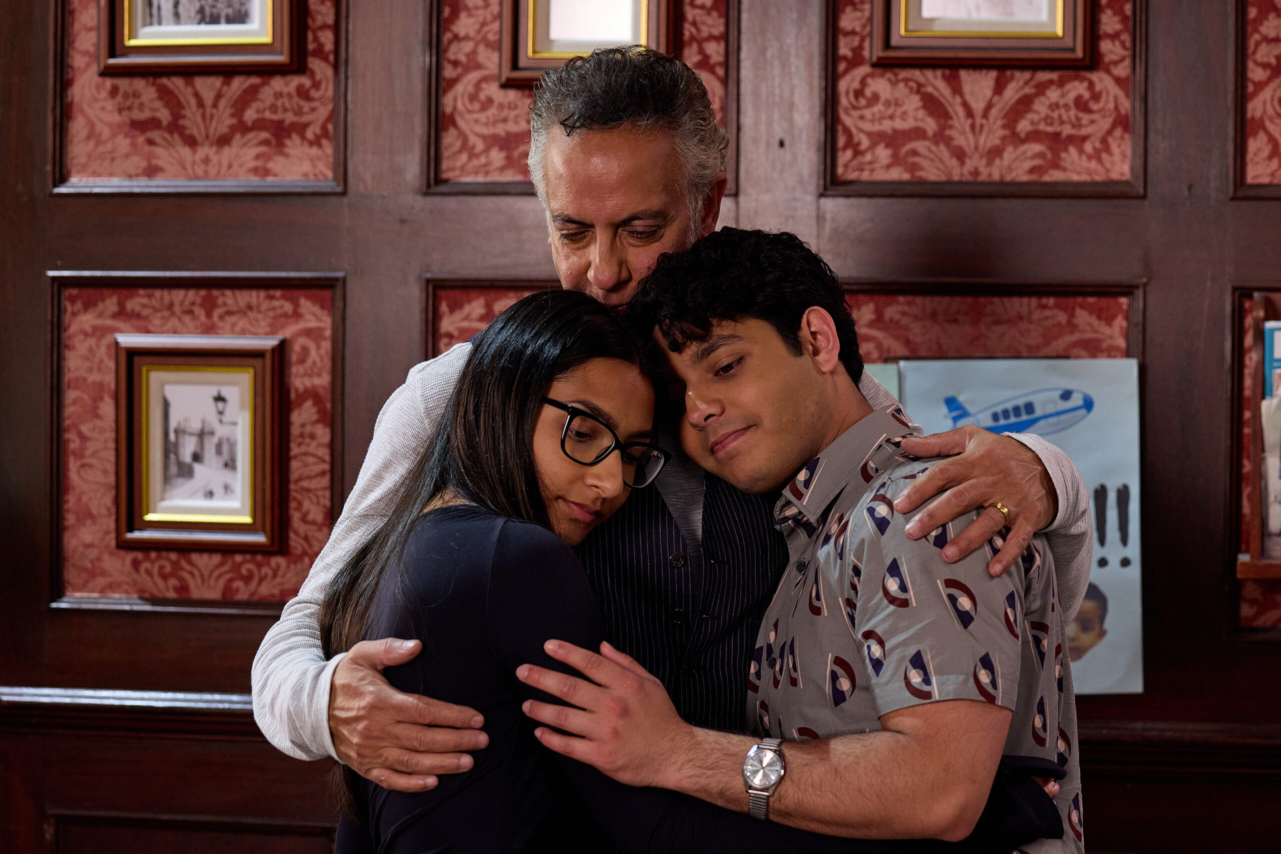 Coronation Street's Asha, Aadi and Dev hugging in the Rovers