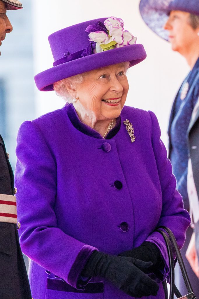 Queen Elizabeth II in purple outfit for royal engagement