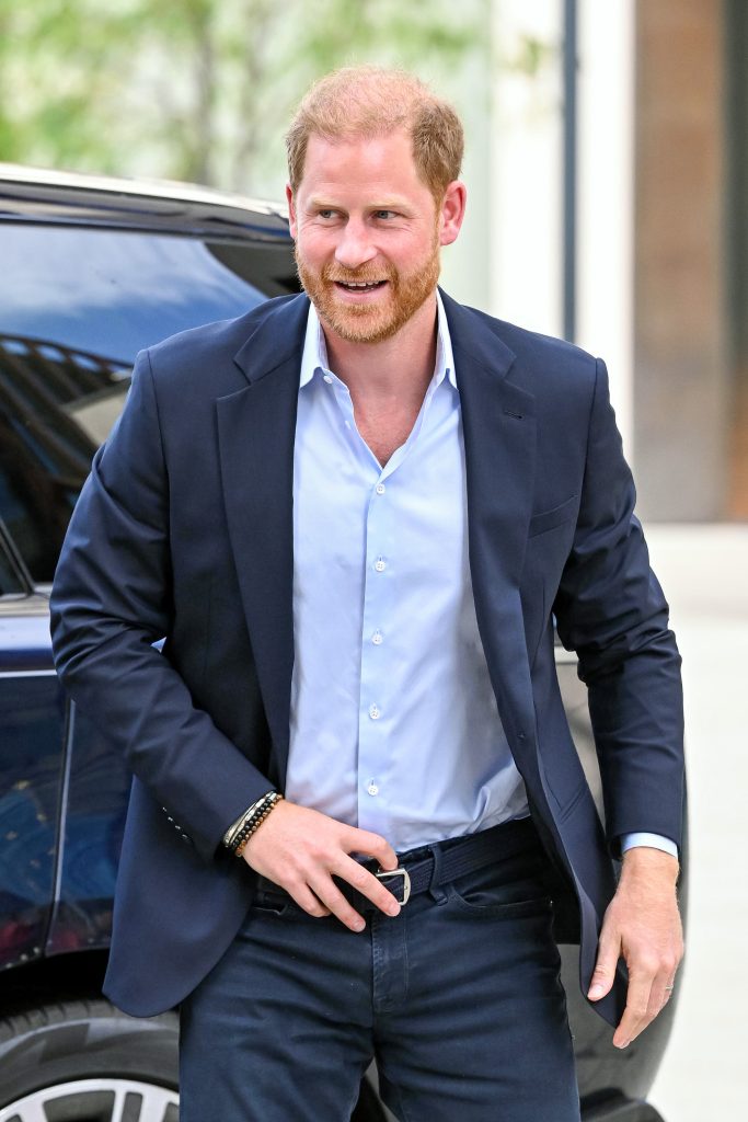 Prince Harry smiling after getting out of a car