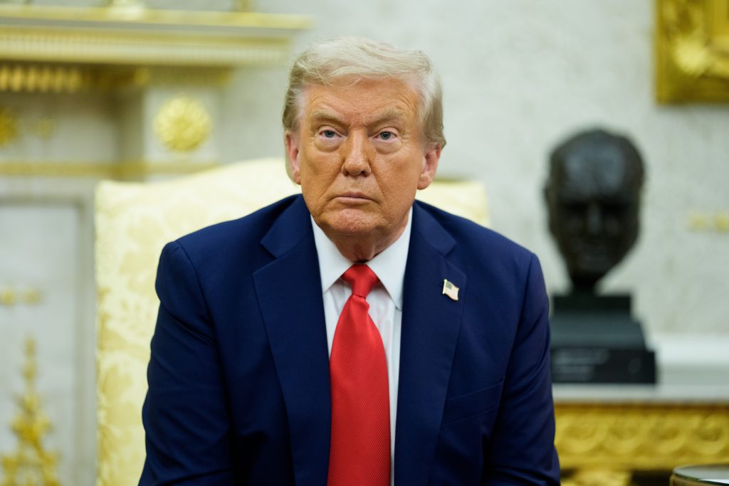 Donald Trump in navy suit in the Oval Office