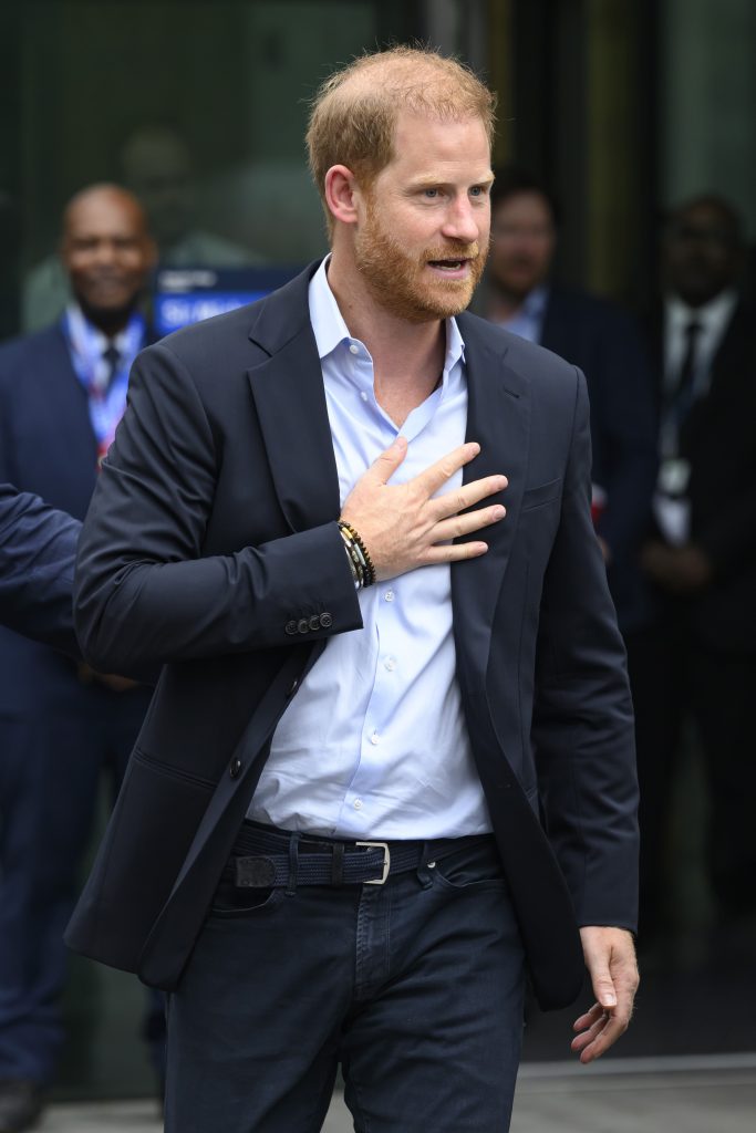Prince Harry with his hand on his chest during UK visit