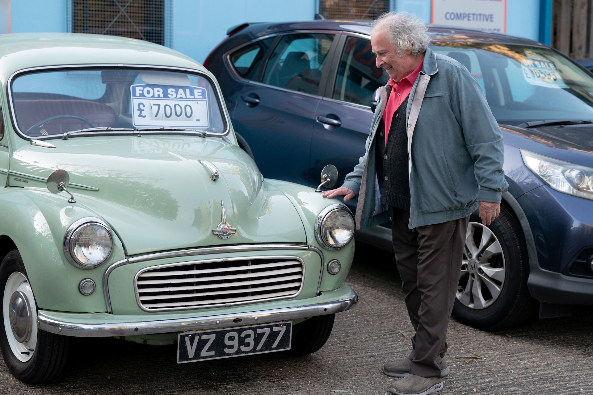 Nigel smiles as he looks at his car