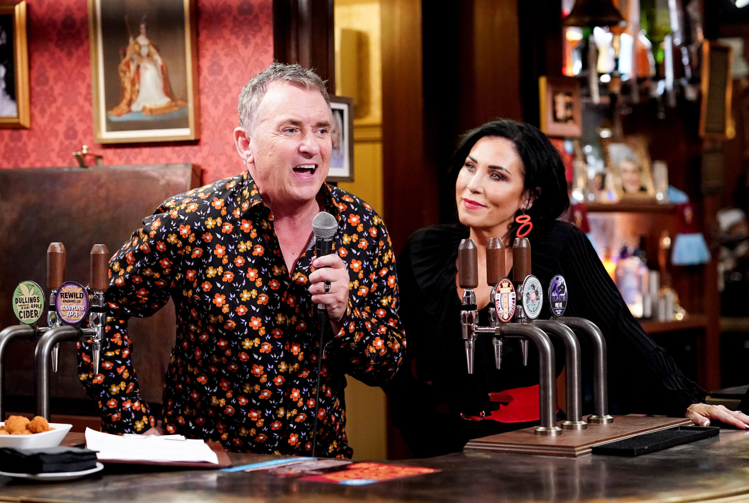Kat looks on as Alfie leads the pub quiz at The Vic