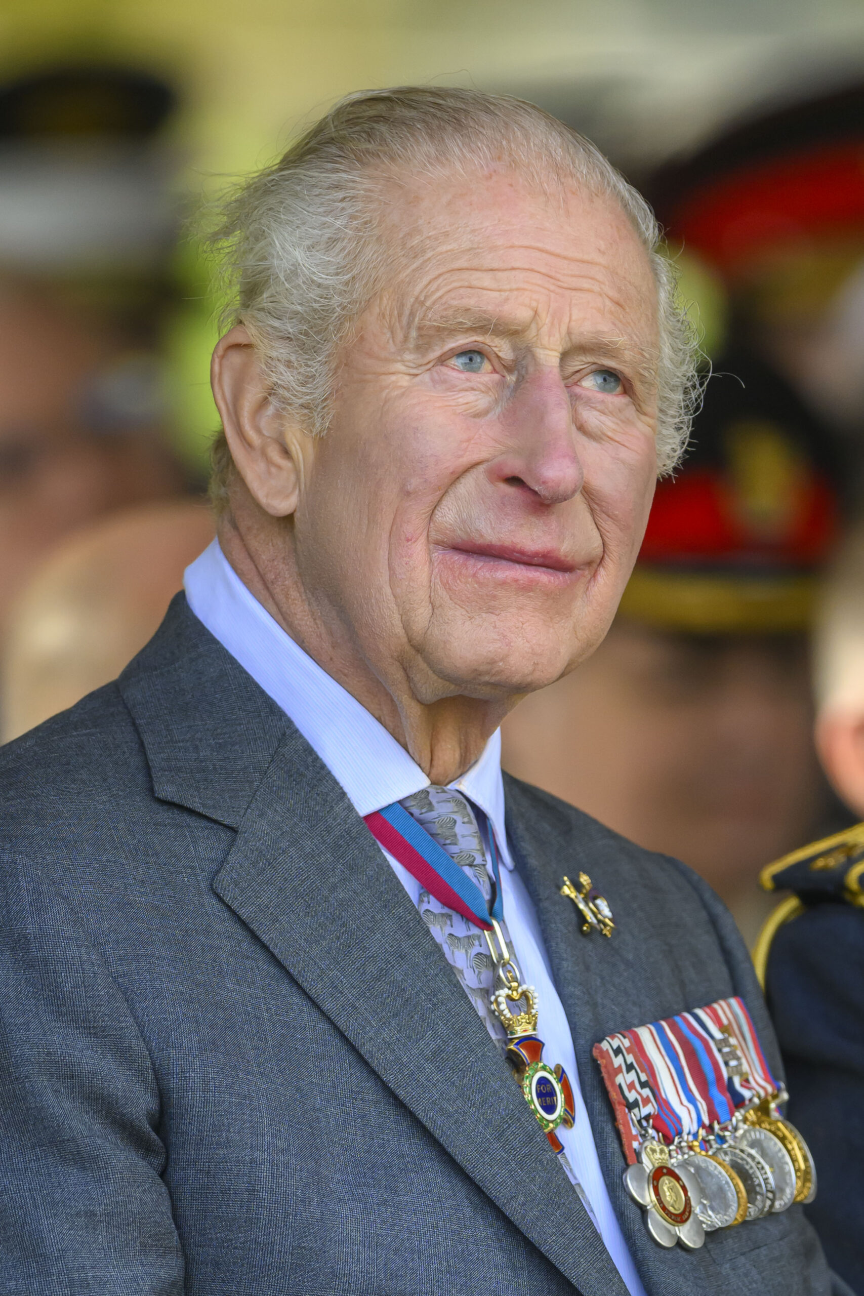 King Charles looking serious in grey suit