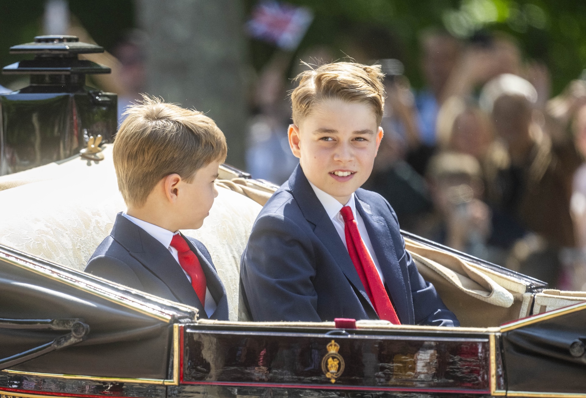 Prince George smiling on carriage 