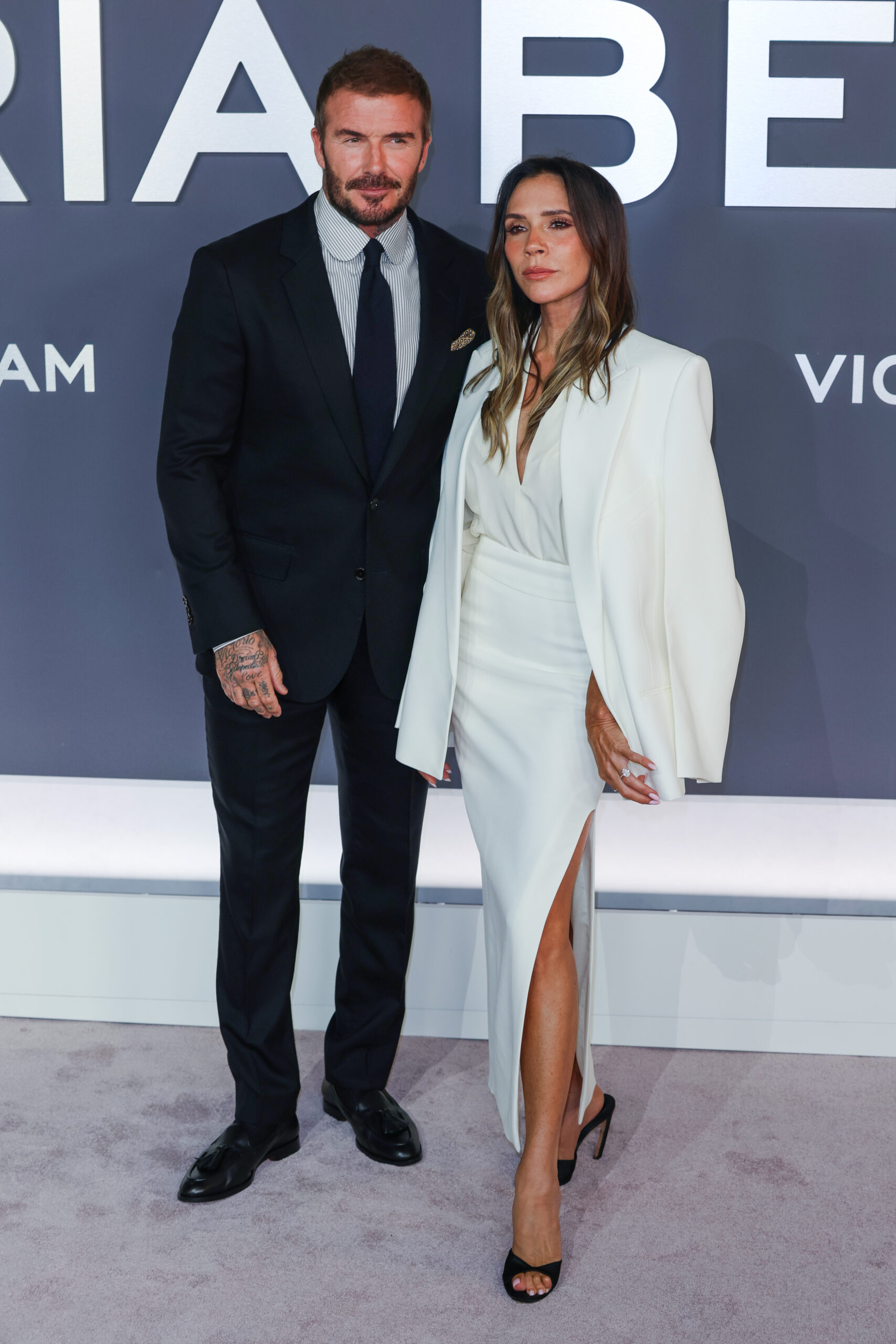 David and Victoria Beckham posing at event