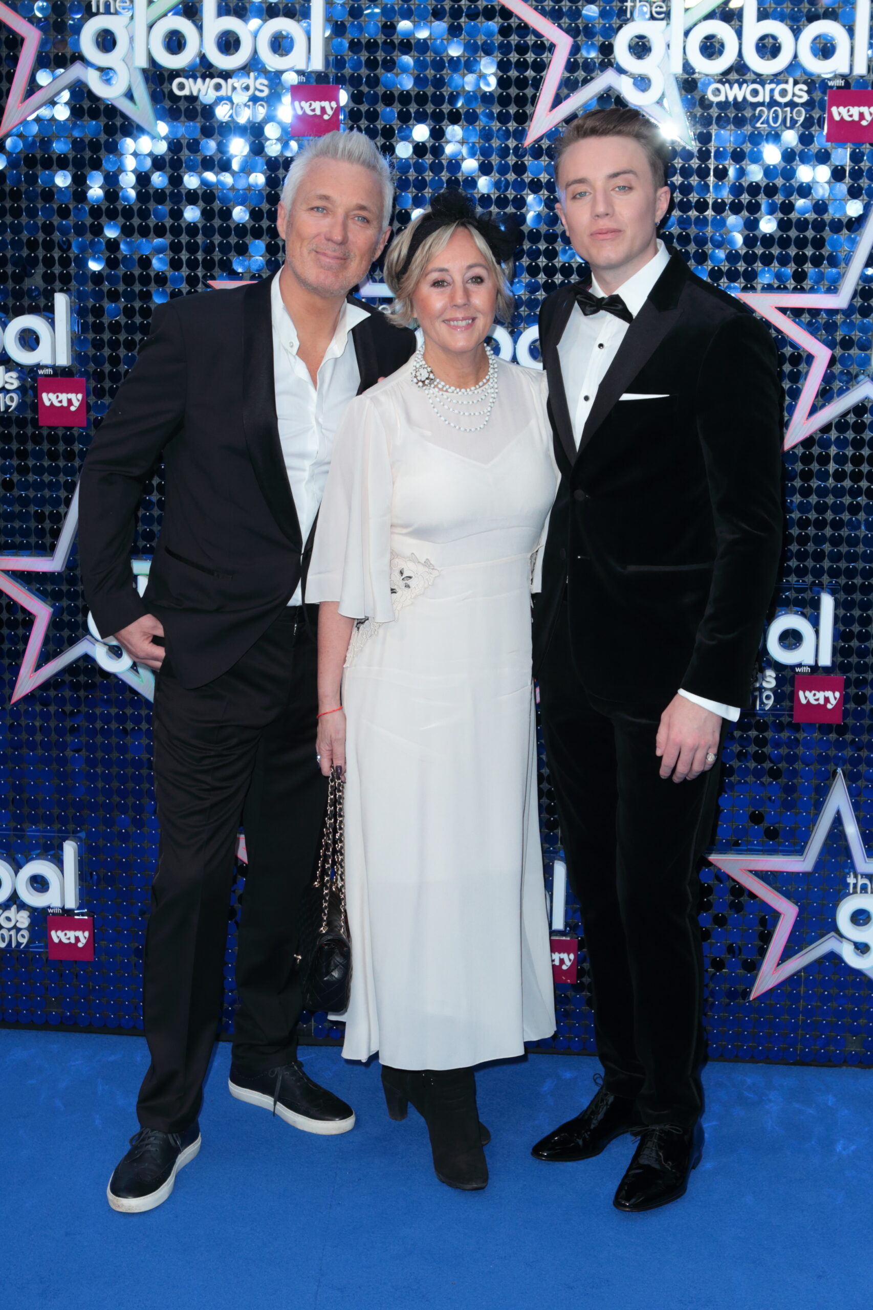 Roman, Martin and Shirlie Kemp posing